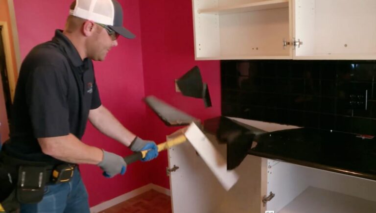 David Shoultz taking a sledgehammer to a kitchen countertop during filming